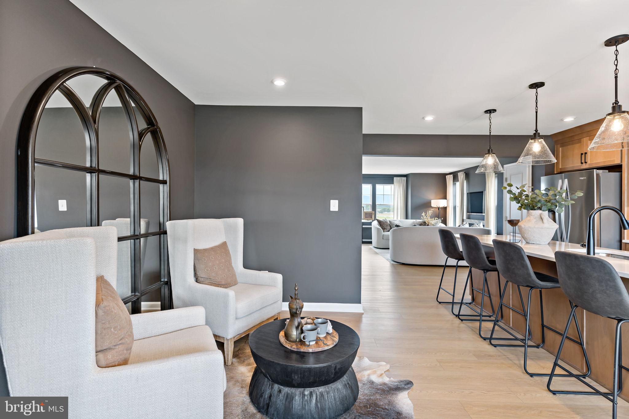 275 Nymph Road Inwood, WV 25428 - Photo 10 of 36 a living room with furniture a dining table and a large window