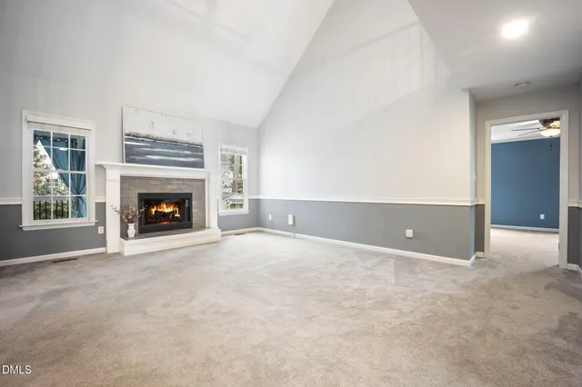 an empty room with furniture and a fireplace