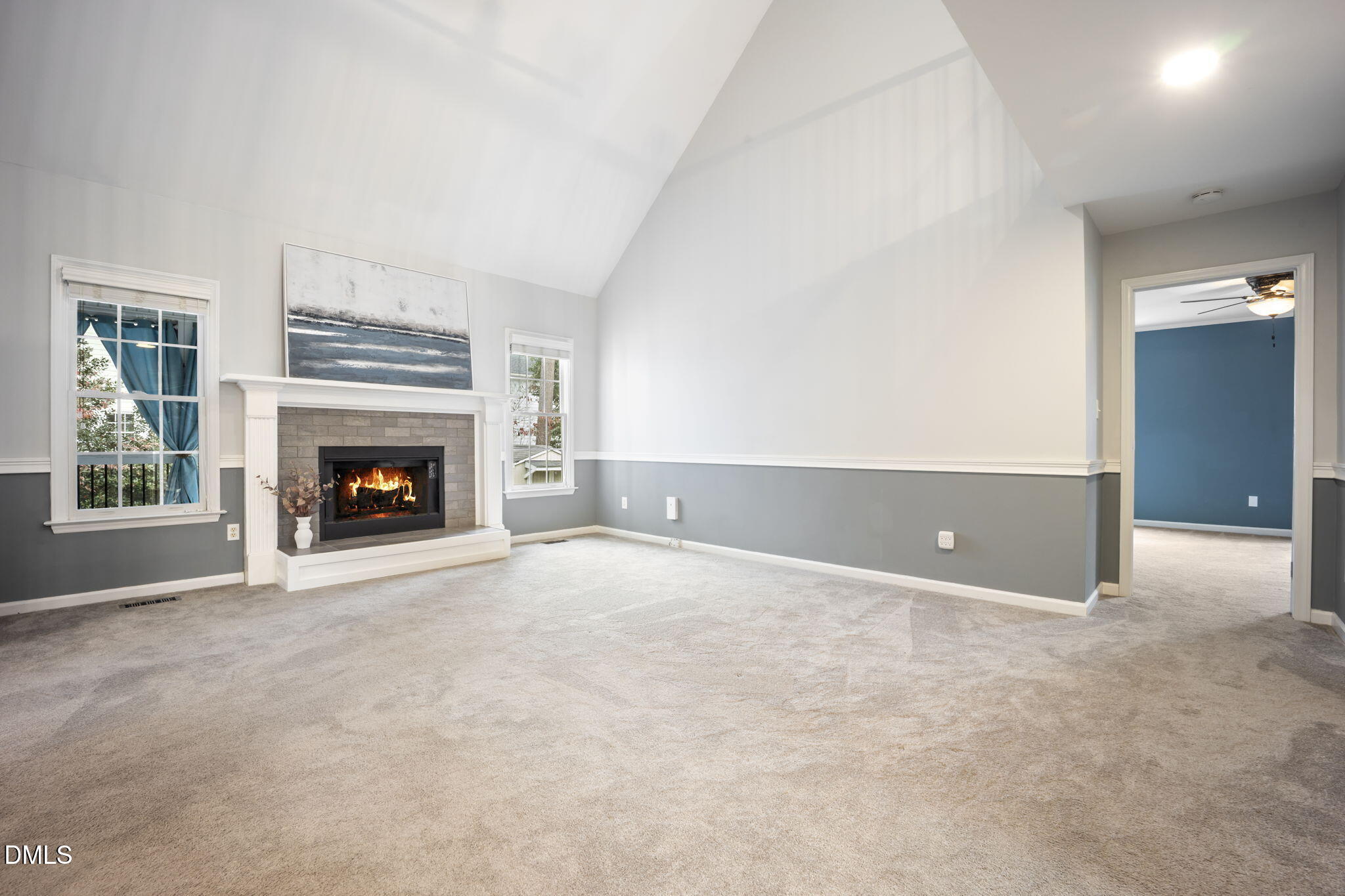 8665 Harps Mill Road Raleigh, NC 27615 - Photo 11 of 36 an empty room with furniture and a fireplace