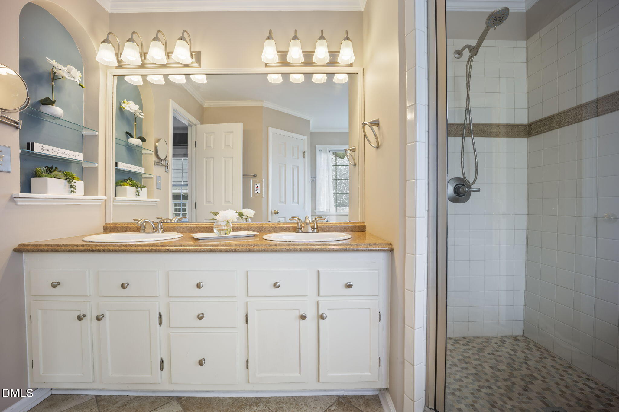 8665 Harps Mill Road Raleigh, NC 27615 - Photo 17 of 36 a bathroom with double vanity sinks a vanity two mirror and a shower