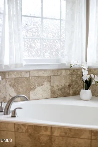 a bathroom with a bathtub and window