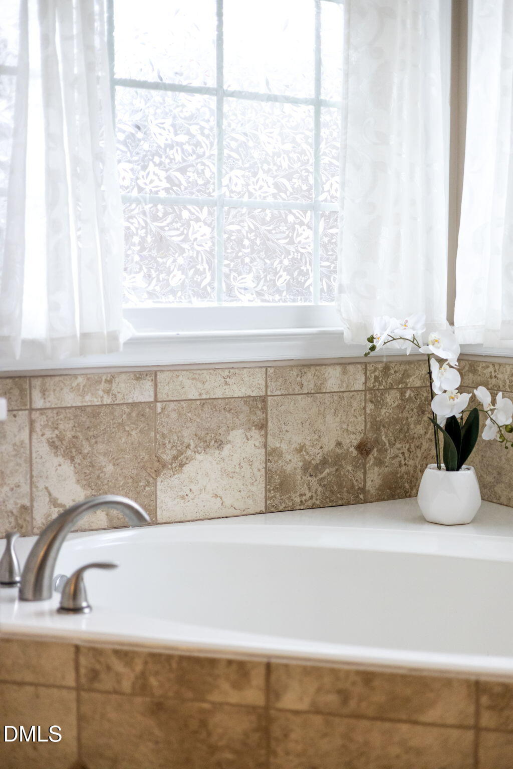 8665 Harps Mill Road Raleigh, NC 27615 - Photo 18 of 36 a bathroom with a bathtub and window