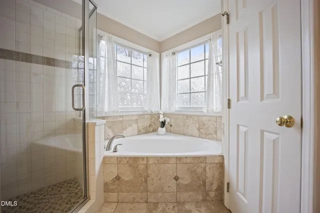 a bath tub sitting in a bathroom next to a window