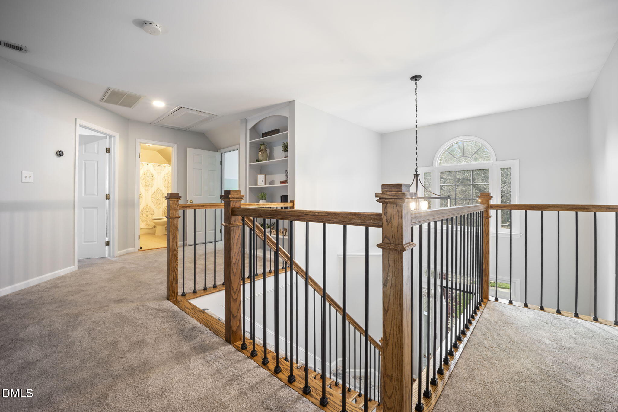 8665 Harps Mill Road Raleigh, NC 27615 - Photo 22 of 36 a view of a hallway with windows