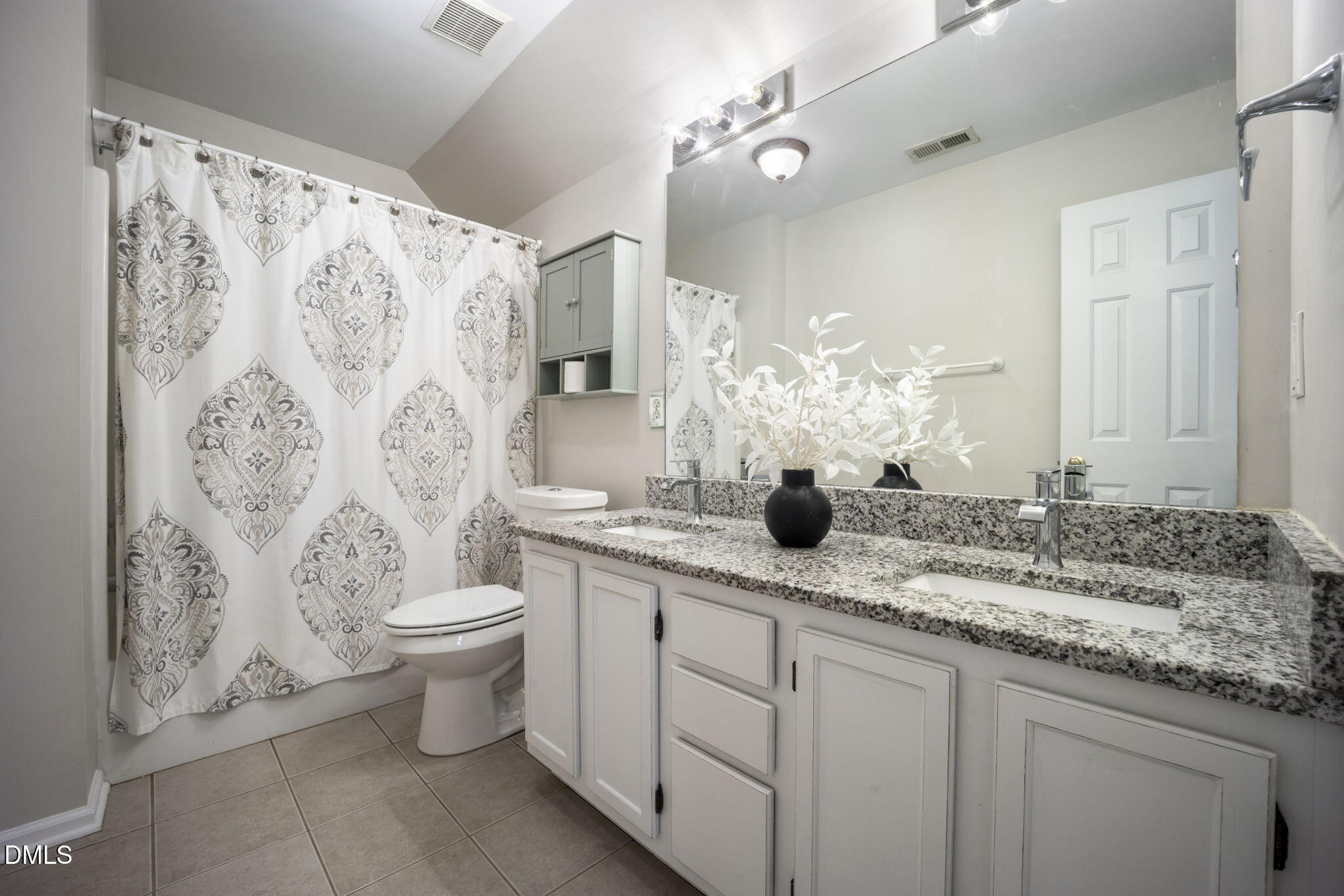 8665 Harps Mill Road Raleigh, NC 27615 - Photo 25 of 36 a bathroom with a granite countertop sink a toilet and a mirror