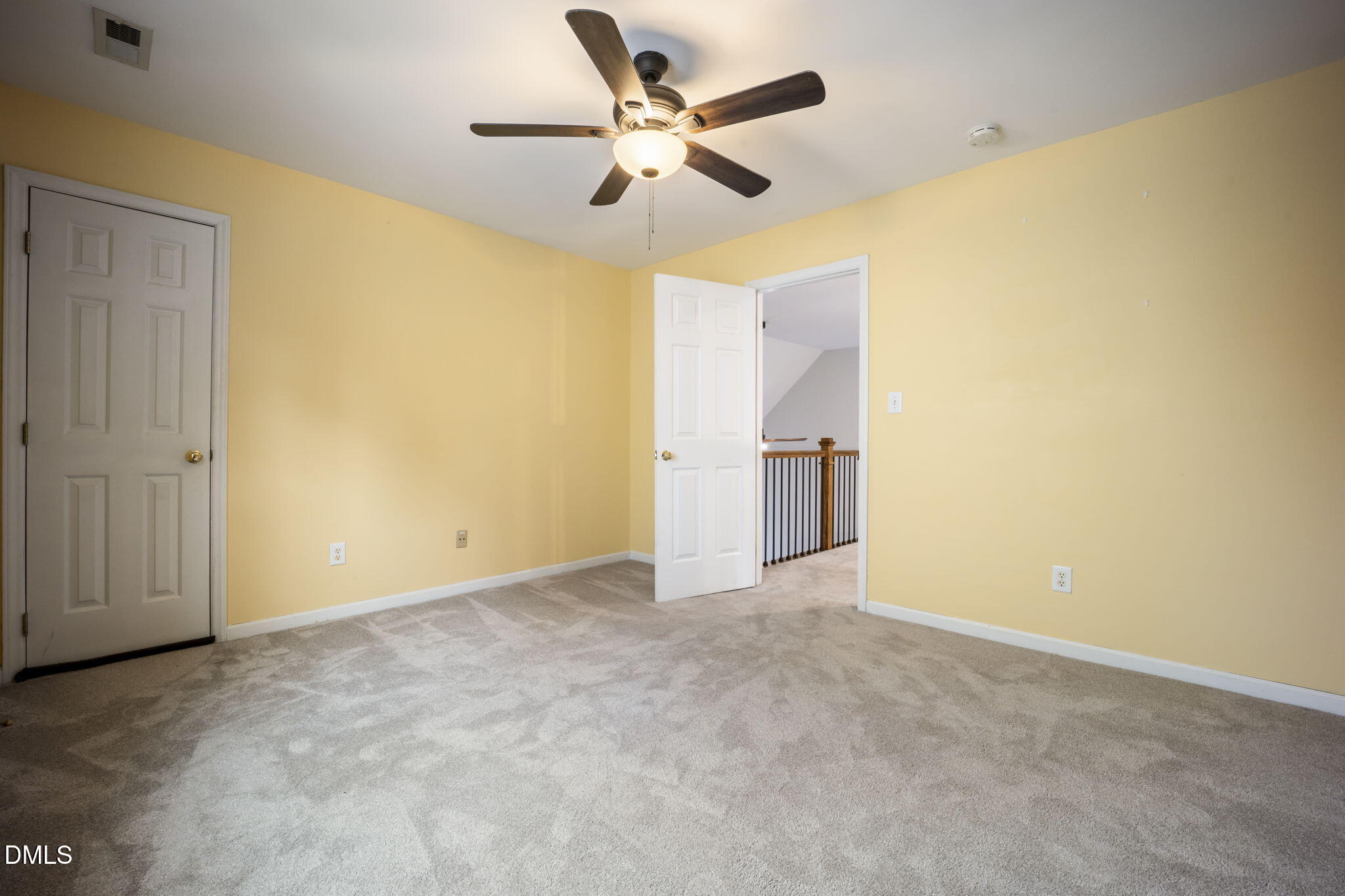 8665 Harps Mill Road Raleigh, NC 27615 - Photo 29 of 36 an empty room with a ceiling fan and a window