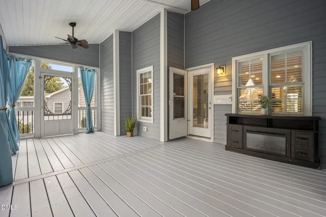 a view of a livingroom with wooden floor and furniture