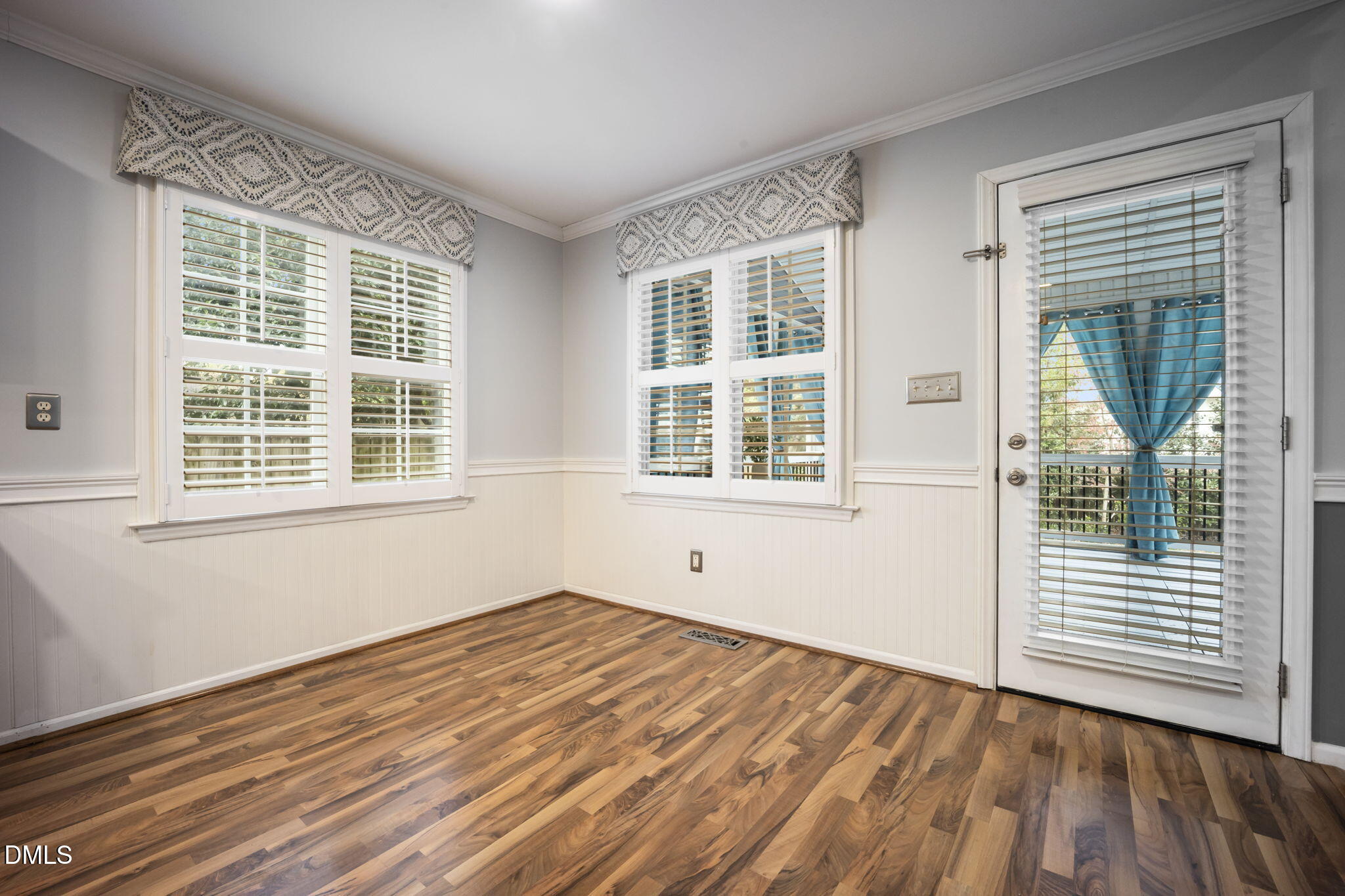 8665 Harps Mill Road Raleigh, NC 27615 - Photo 10 of 36 a view of empty room with wooden floor and fan