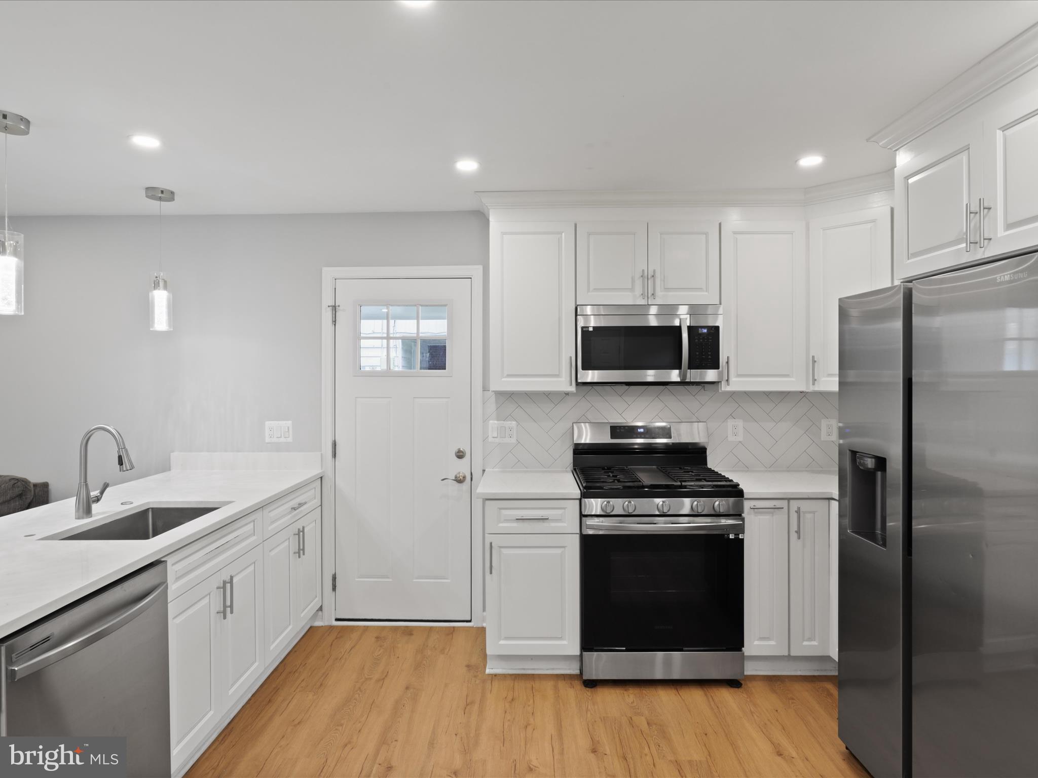 7435 Bath Street Springfield, VA 22150 - Photo 11 of 28 a kitchen with a sink stove and refrigerator