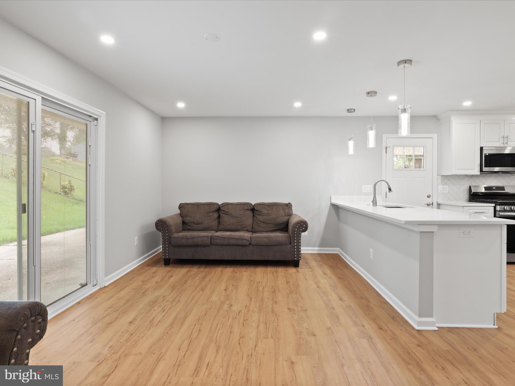 7435 Bath Street Springfield, VA 22150 - Photo 14 of 28 a living room with furniture and a wooden floor