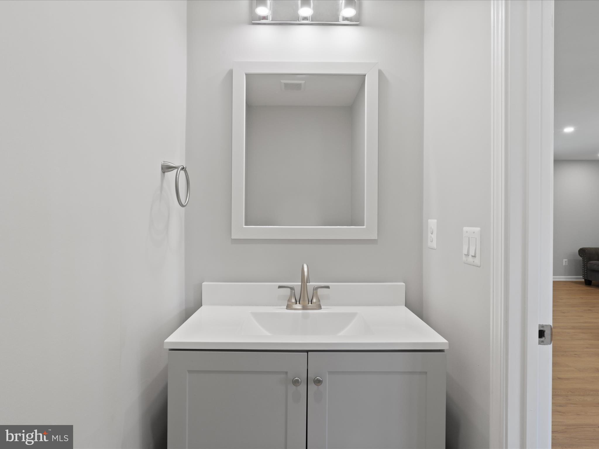 7435 Bath Street Springfield, VA 22150 - Photo 16 of 28 a bathroom with a sink and mirror