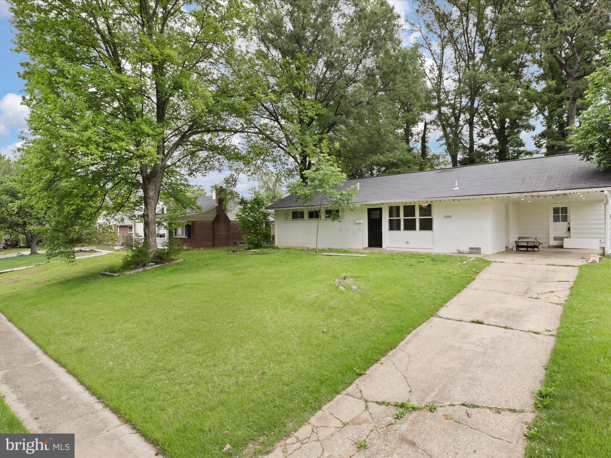 7435 Bath Street Springfield, VA 22150 - Photo 3 of 28 a front view of a house with a yard and trees