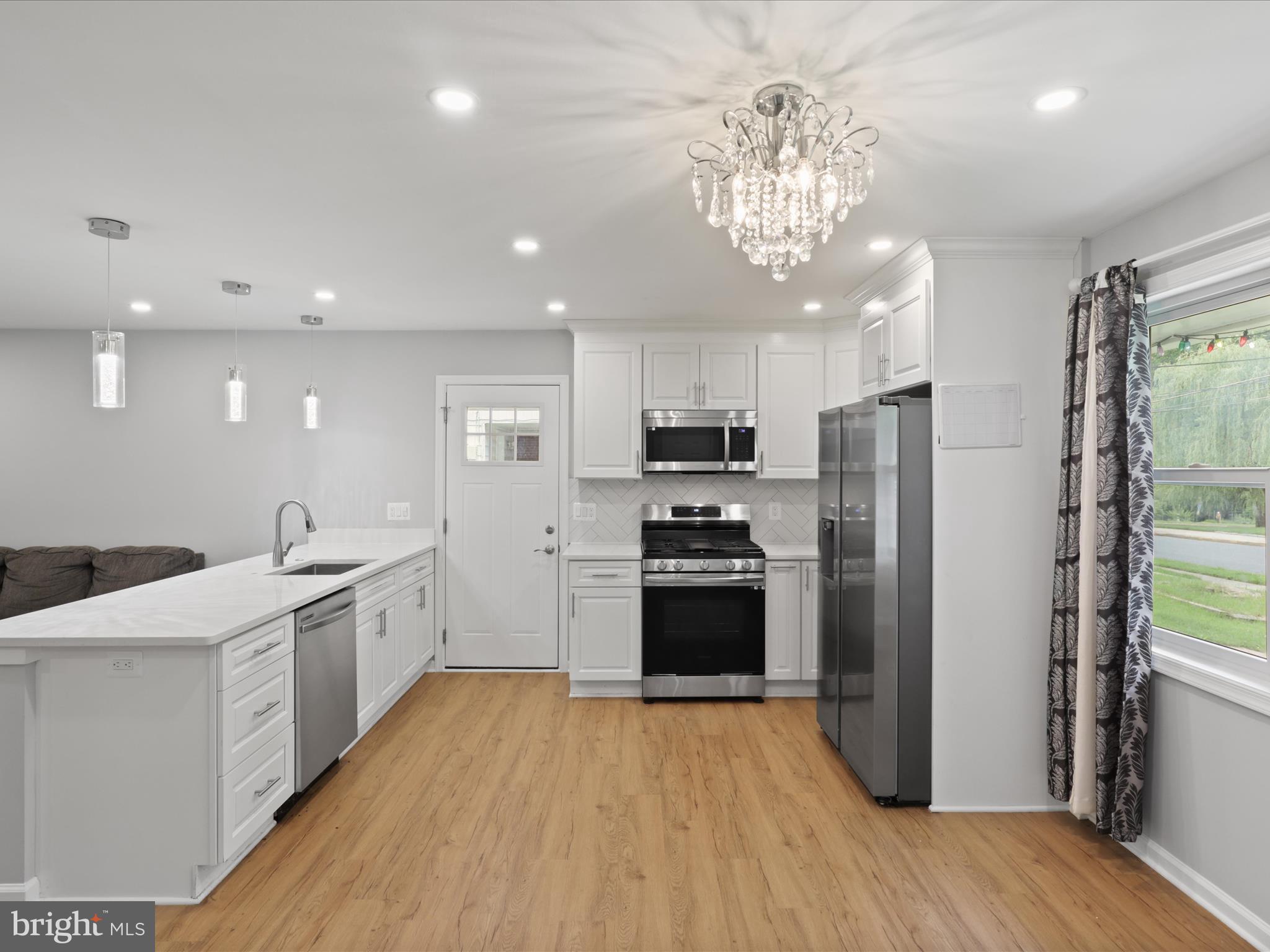 7435 Bath Street Springfield, VA 22150 - Photo 10 of 28 a kitchen with stainless steel appliances a refrigerator sink and stove
