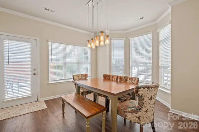 a view of a dining room with furniture and window