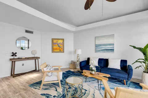 a work place with stainless steel appliances kitchen island granite countertop furniture and a dining table