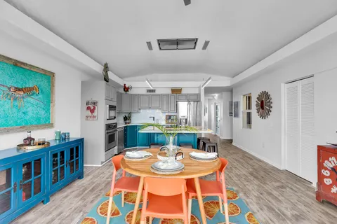 a kitchen with a table chairs in front of it and white walls