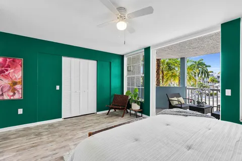 a bedroom with a bed and a large window