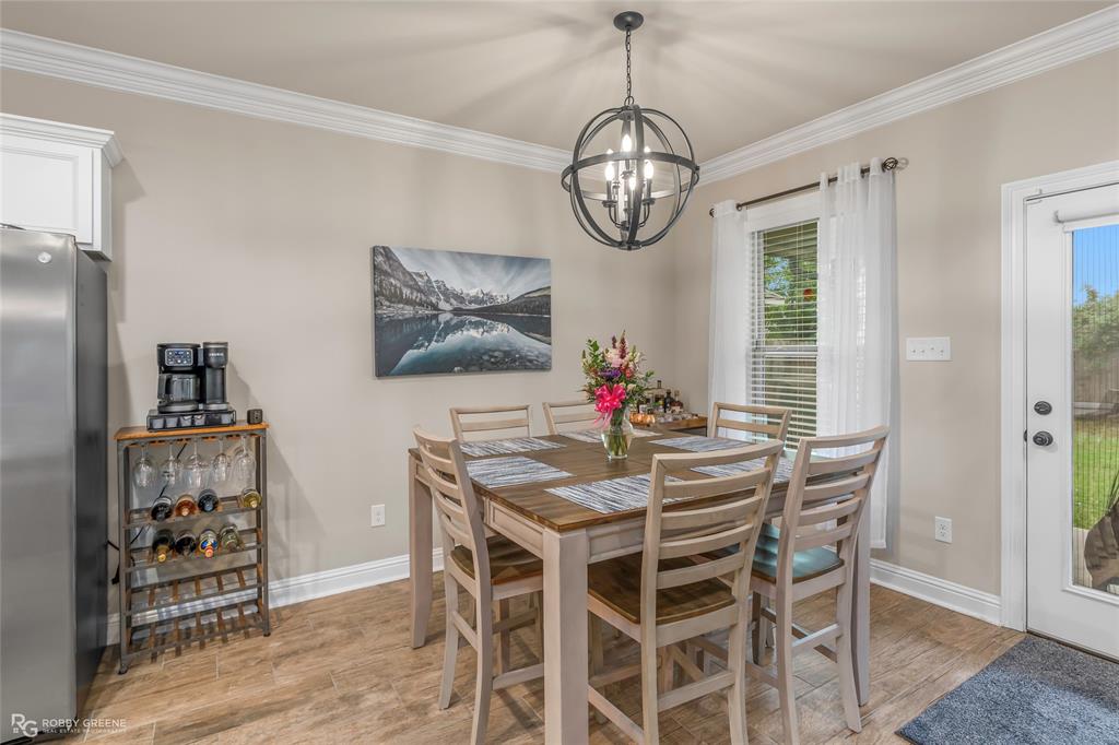 122 Brimestone Loop Benton, LA 71006 - Photo 13 of 33 a view of a dining room with furniture wooden floor and chandelier