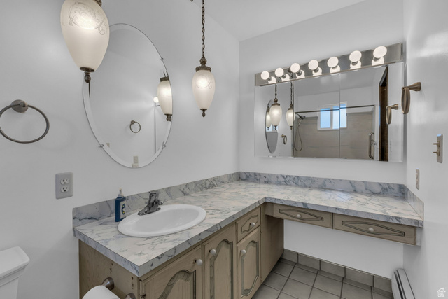 10705 Green Ridge Drive Sandy, UT 84070 - Photo 18 of 55 Full bath with vanity, a baseboard radiator, a shower, and light tile patterned floors