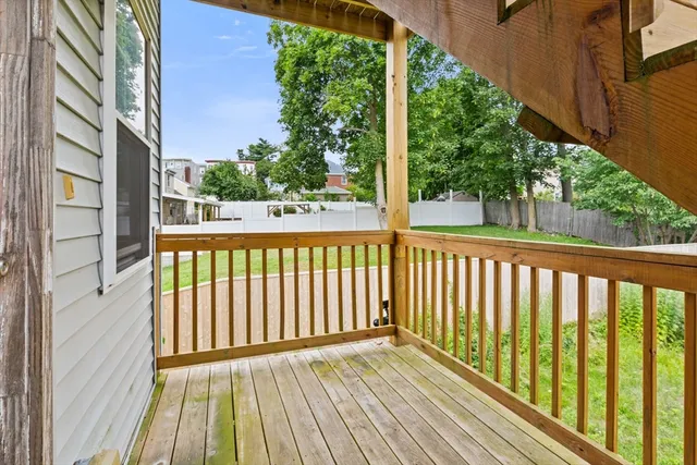 a view of a balcony with wooden floor