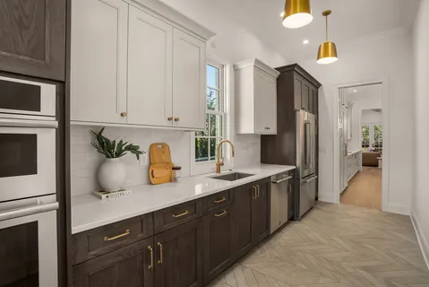 a bedroom with a bed ceiling fan and a wooden floor
