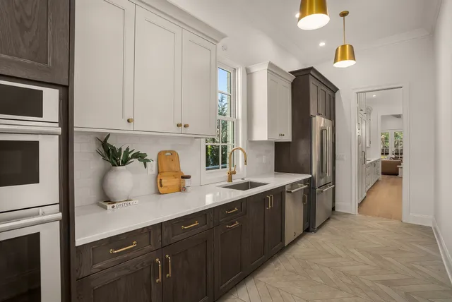 a bedroom with a bed ceiling fan and a wooden floor