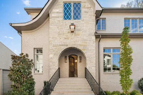 a large kitchen with stainless steel appliances a large center island attached withe living room