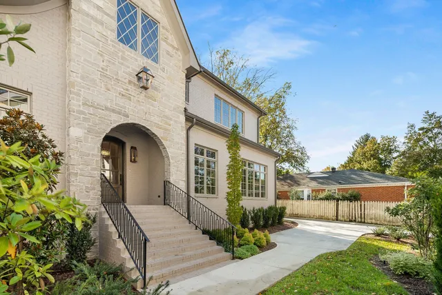 a living room with fireplace furniture and a large mirror