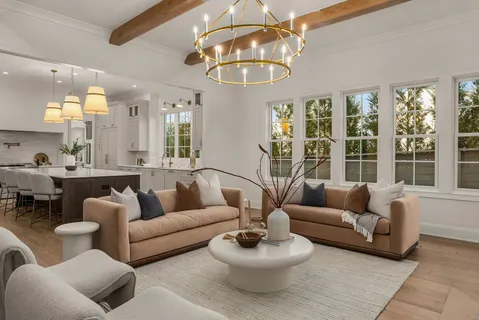 a kitchen with stainless steel appliances granite countertop a stove a chimney a sink and a dining table with garden view