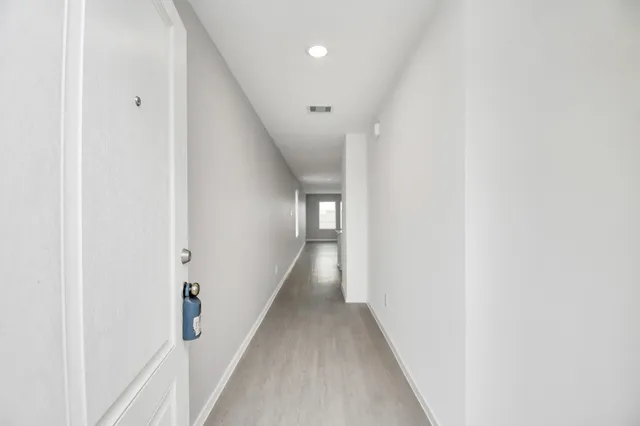 a view of a hallway with a white walls