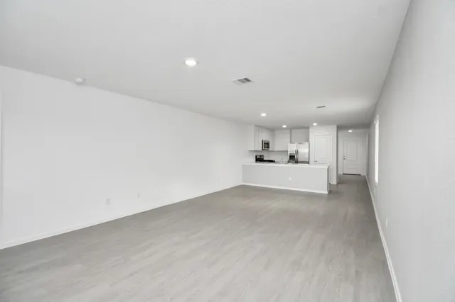 a view of a livingroom with kitchen