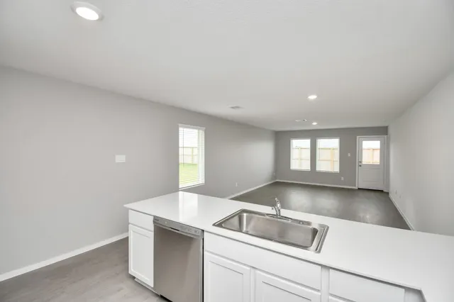a kitchen with a sink cabinets and a window