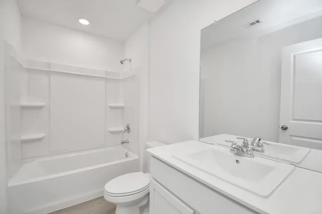 a bathroom with a sink a toilet and a bathtub