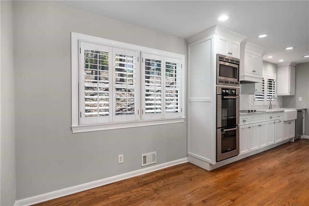 3240 Pinestream Road Northwest Atlanta, GA 30327 - Photo 12 of 42 an empty room with wooden floor and windows