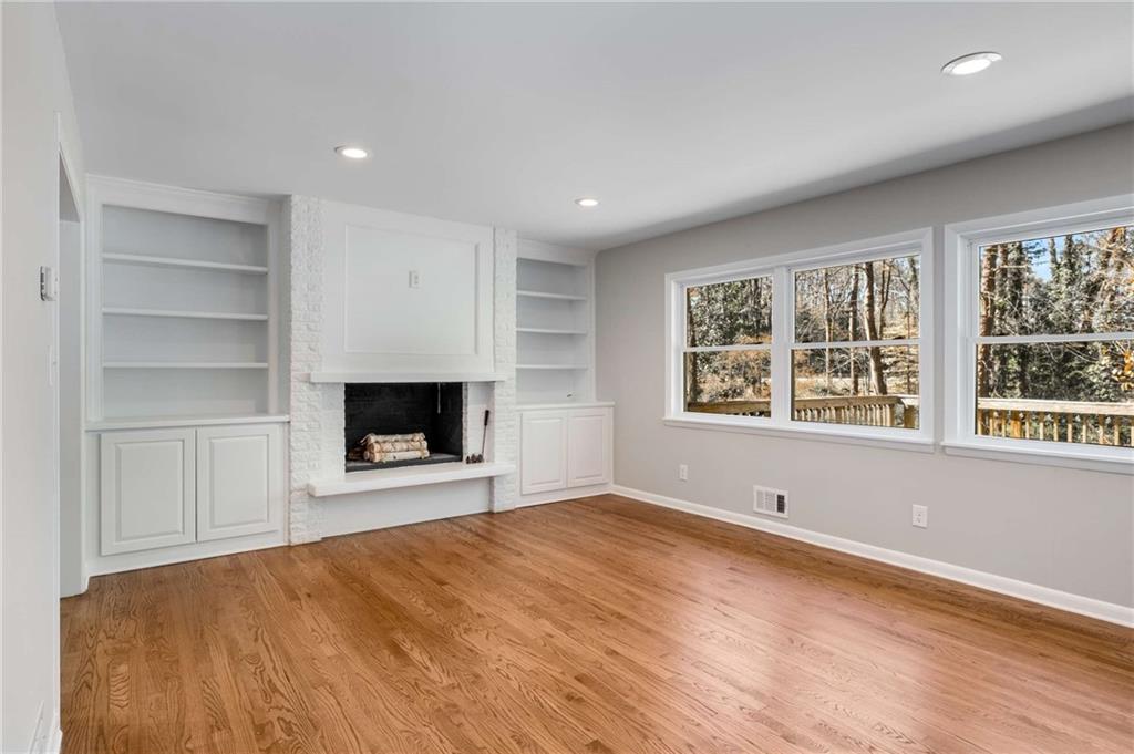 3240 Pinestream Road Northwest Atlanta, GA 30327 - Photo 15 of 42 a view of an empty room with a window and a kitchen