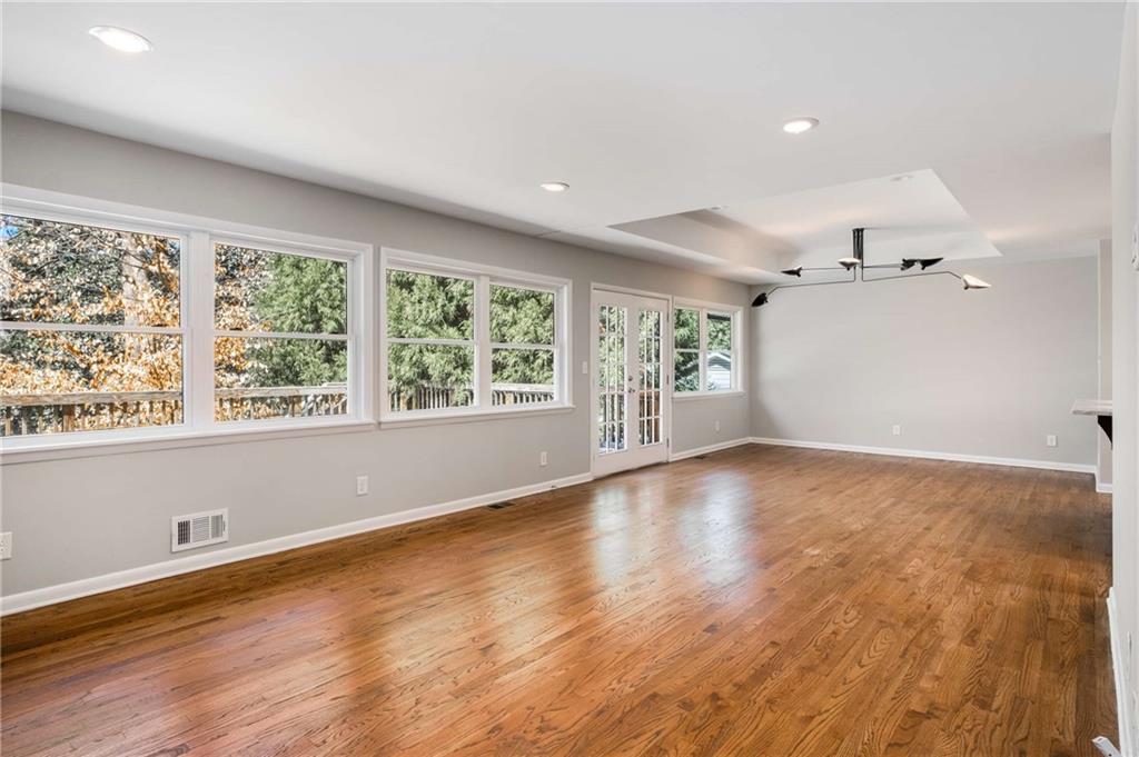 3240 Pinestream Road Northwest Atlanta, GA 30327 - Photo 18 of 42 an empty room with wooden floor and windows