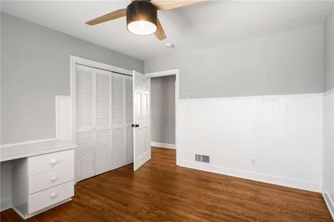 a bathroom with a granite countertop sink mirror and a window