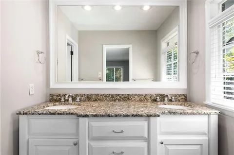 a bathroom with a shower and window