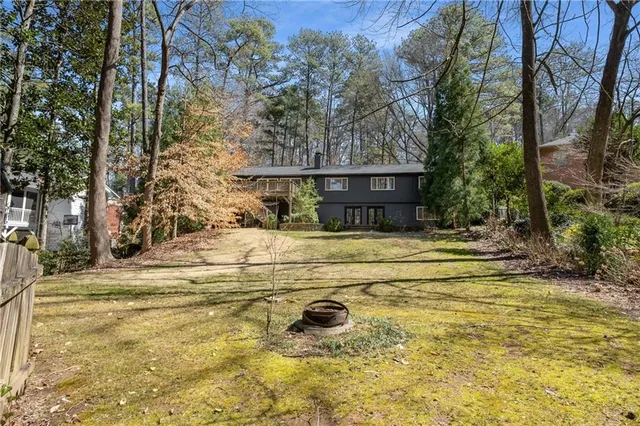 a view of a yard with plants and trees