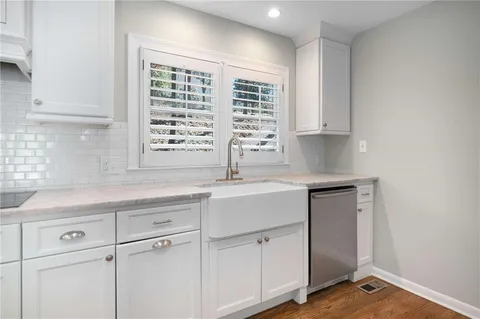 a kitchen with appliances cabinets and a sink