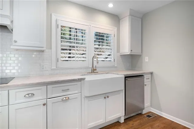 a kitchen with appliances cabinets and a sink