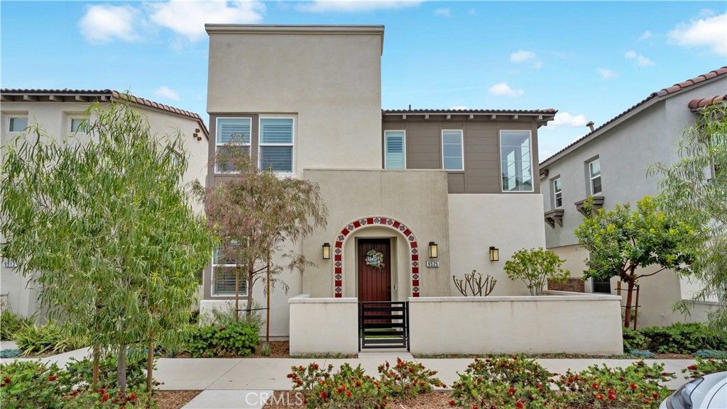 a front view of a house with plants