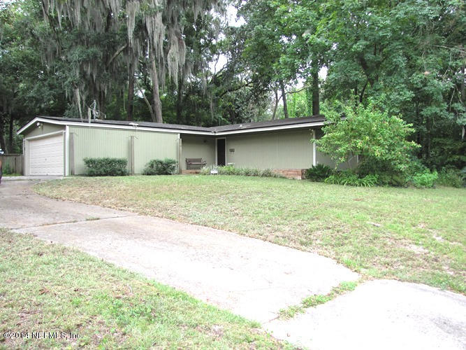 6442 Ferber Road Jacksonville, FL 32277 - Photo 1 of 22 a backyard of a house with large trees and garage