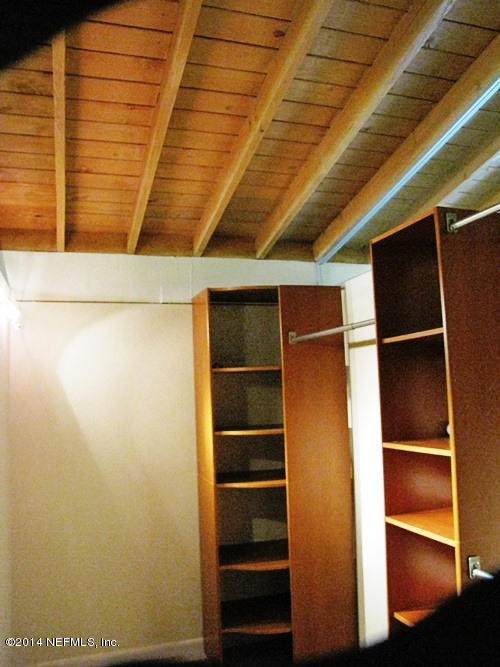 6442 Ferber Road Jacksonville, FL 32277 - Photo 17 of 22 a view of walk in closet with empty racks