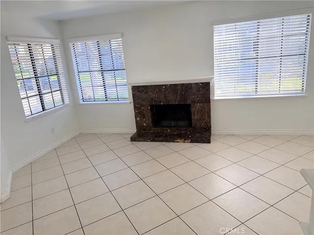 a living room with a fireplace and a large window
