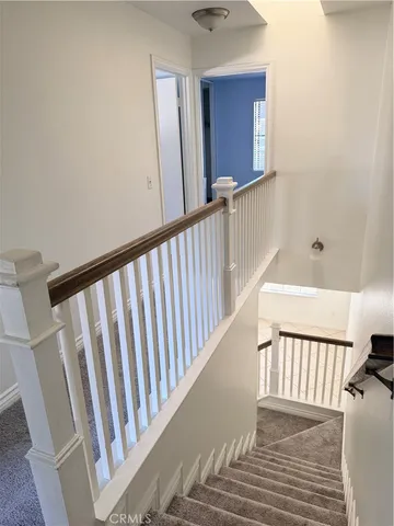 a view of a hallway with stairs
