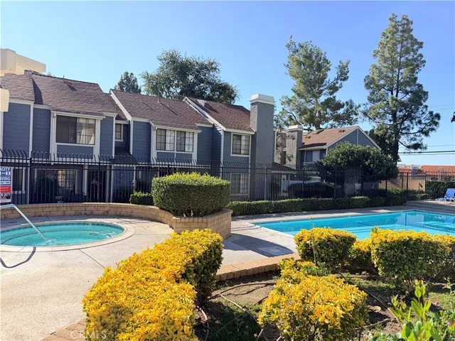 a view of a house with swimming pool and sitting area