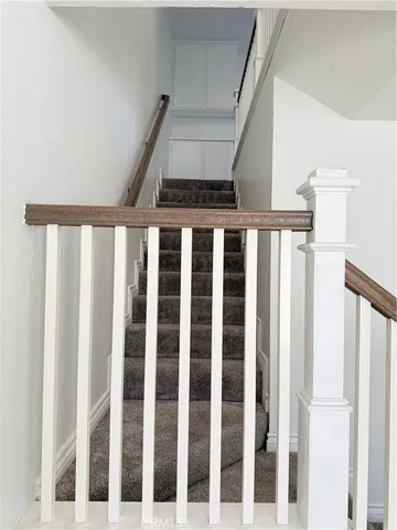 a view of a hallway with wooden floor and entryway