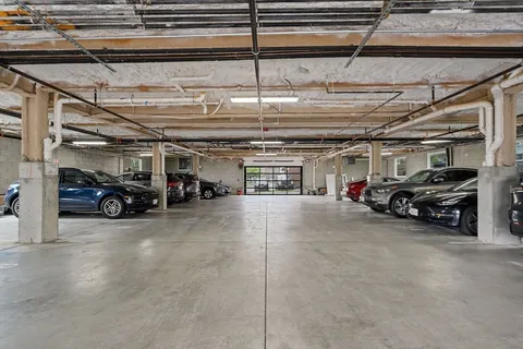 a view of parking garage with cars