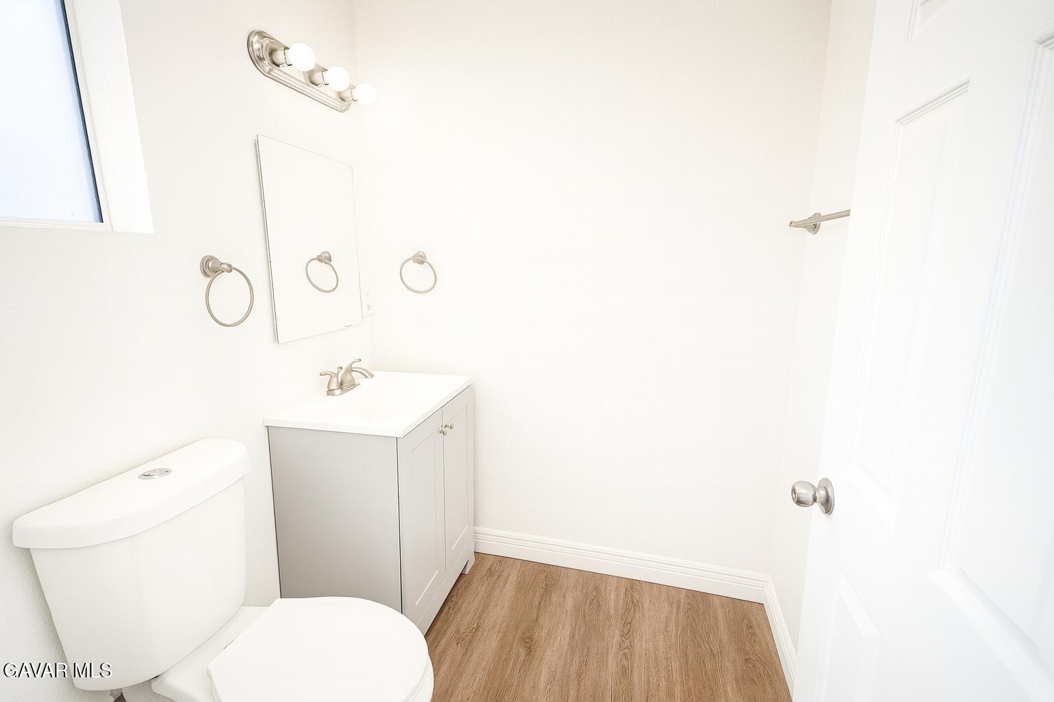 8445 Gaskell Road Rosamond, CA 93560 - Photo 11 of 13 a bathroom with a toilet sink and mirror